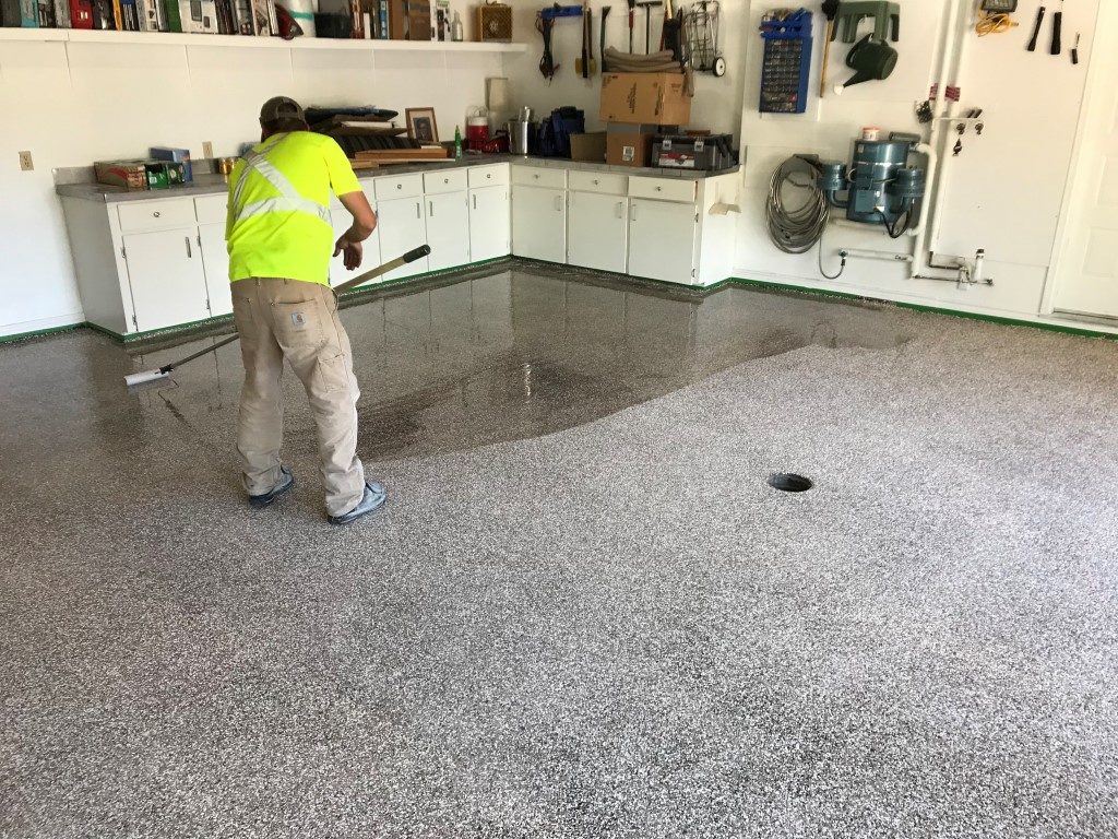 A photo of a worker creating Epoxy Flooring